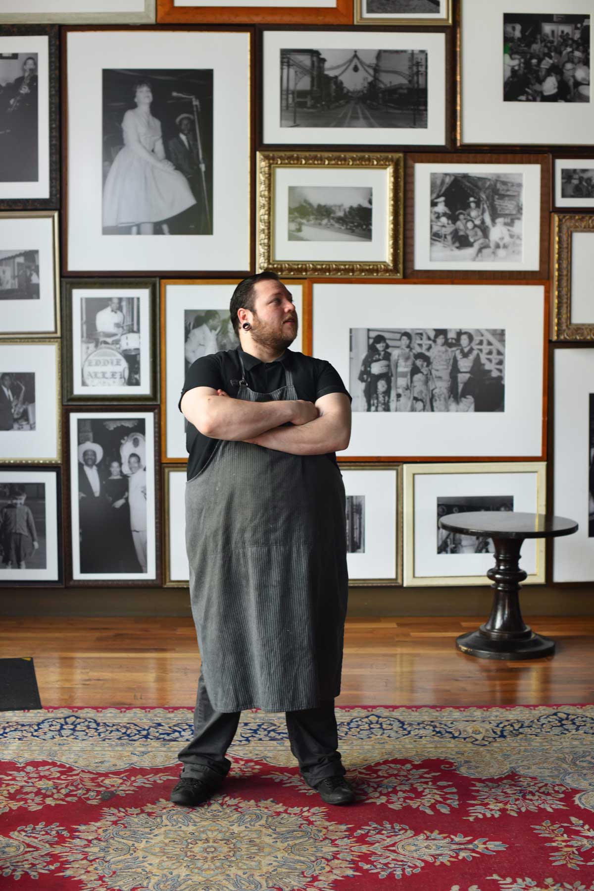Chef Jake stands in the grand photo-filled room near the entrance of 1300 on Fillmore, which pays omage to the rich jazz history of the neighborhood. 