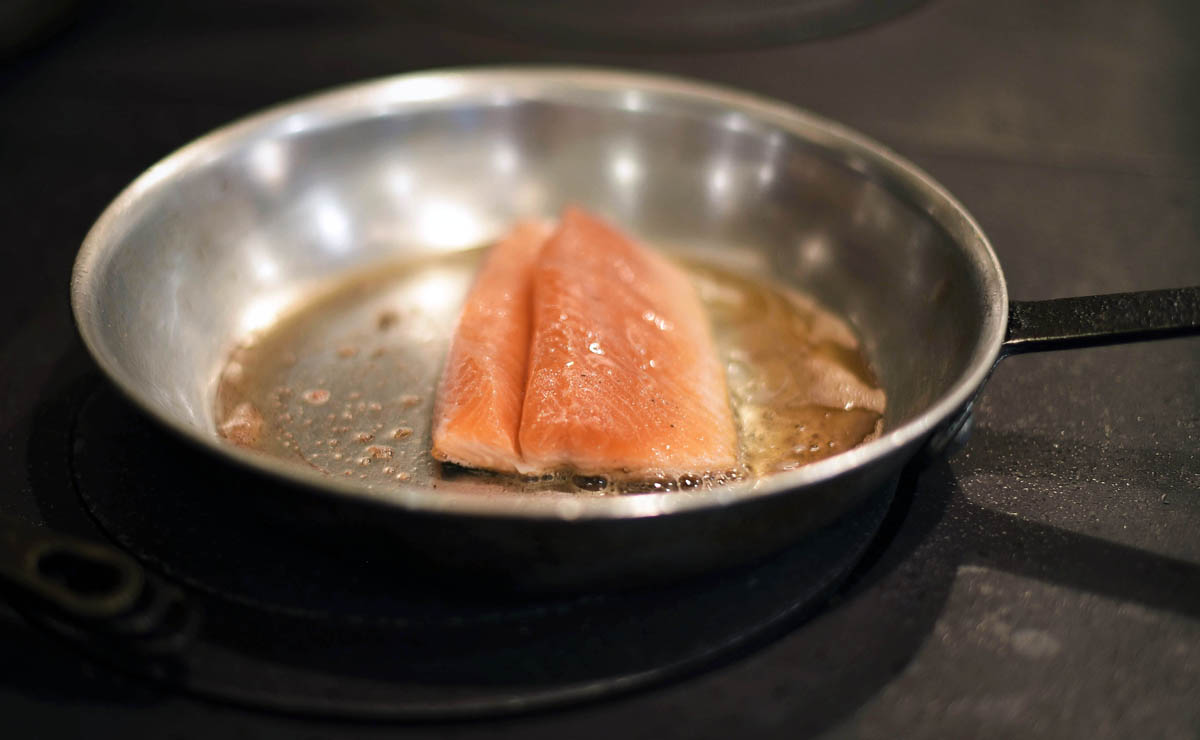 Chef Matthew Dolan finishes searing salmon 