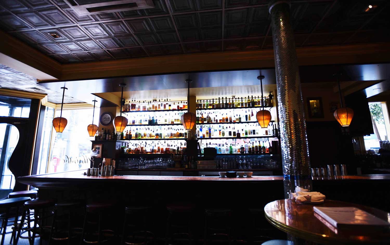 Beautiful bottles line the bright windows of Absinthe Brasserie & Bar