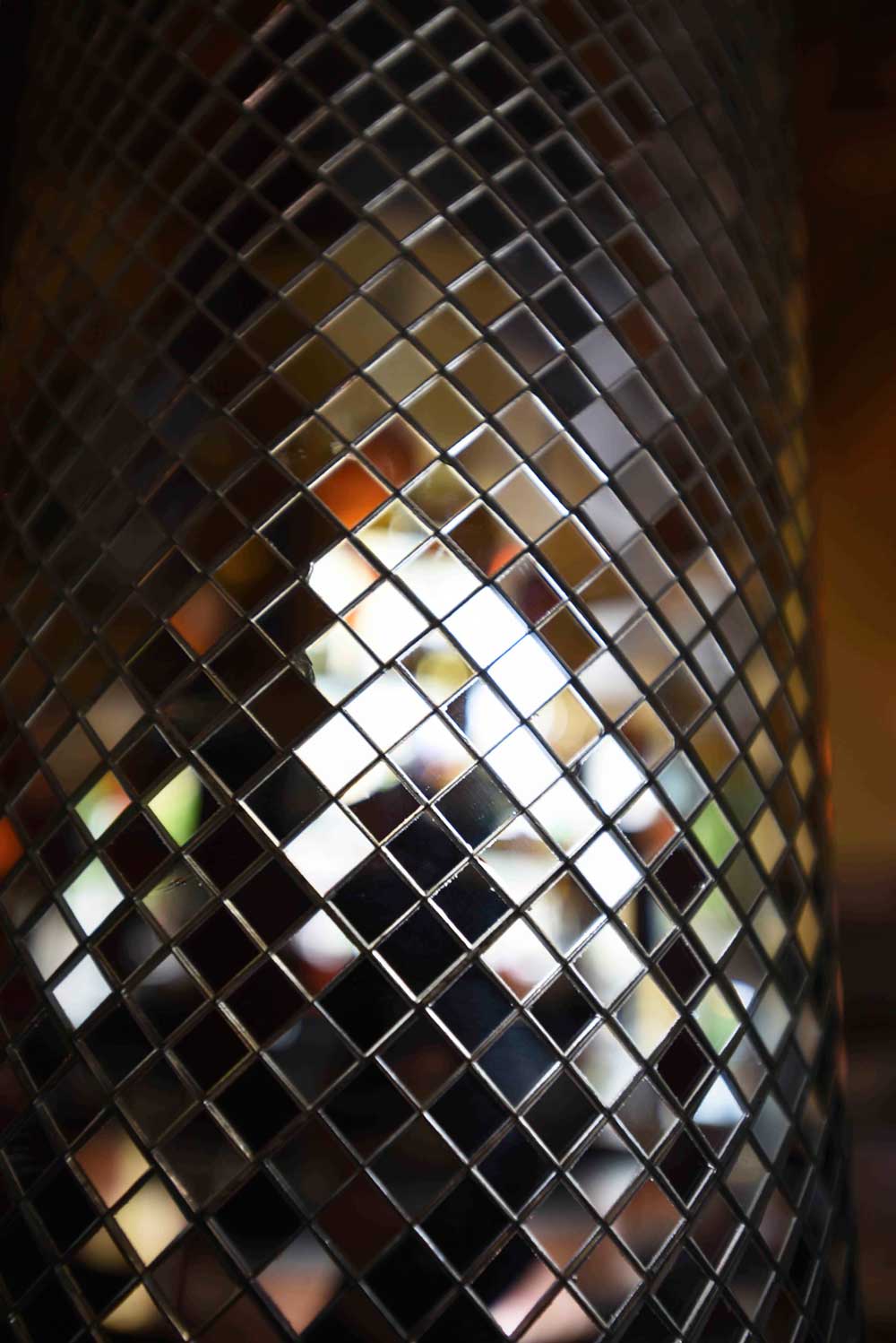The gorgeous mirrored mosaic column harkens to France's art deco era
