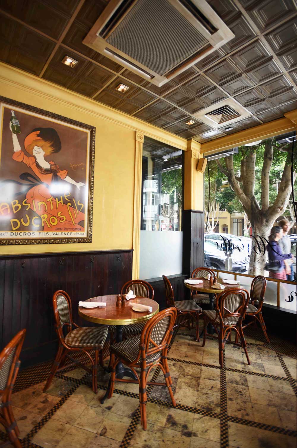 Warm walls and turn-of-the-century lithograph prints adorn the walls of the Brasserie