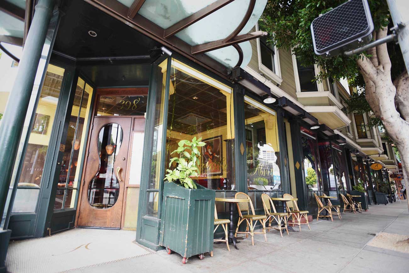 Parisian cafe style chairs line the front of both Arlequin Cafe and Absinthe Brasserie & Bar