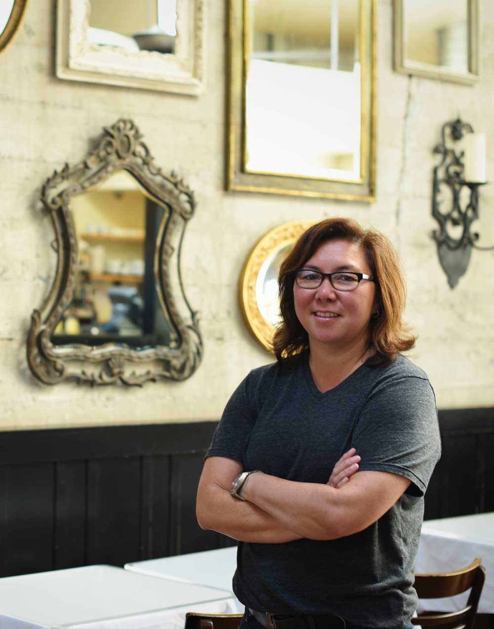 Chef Brenda in front of the wall of mirrors