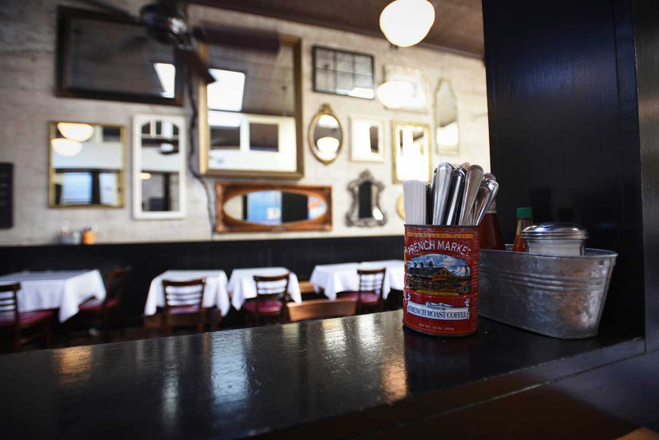 French market coffee cans line the mid-restaurant bar counter.