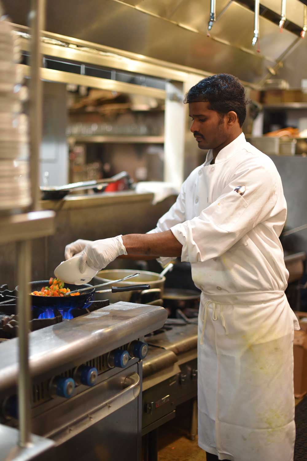 The chef at Dosa works in a large multi-stationed kitchen at the Fillmore location and serves upscale, modern South Indian cuisine. 