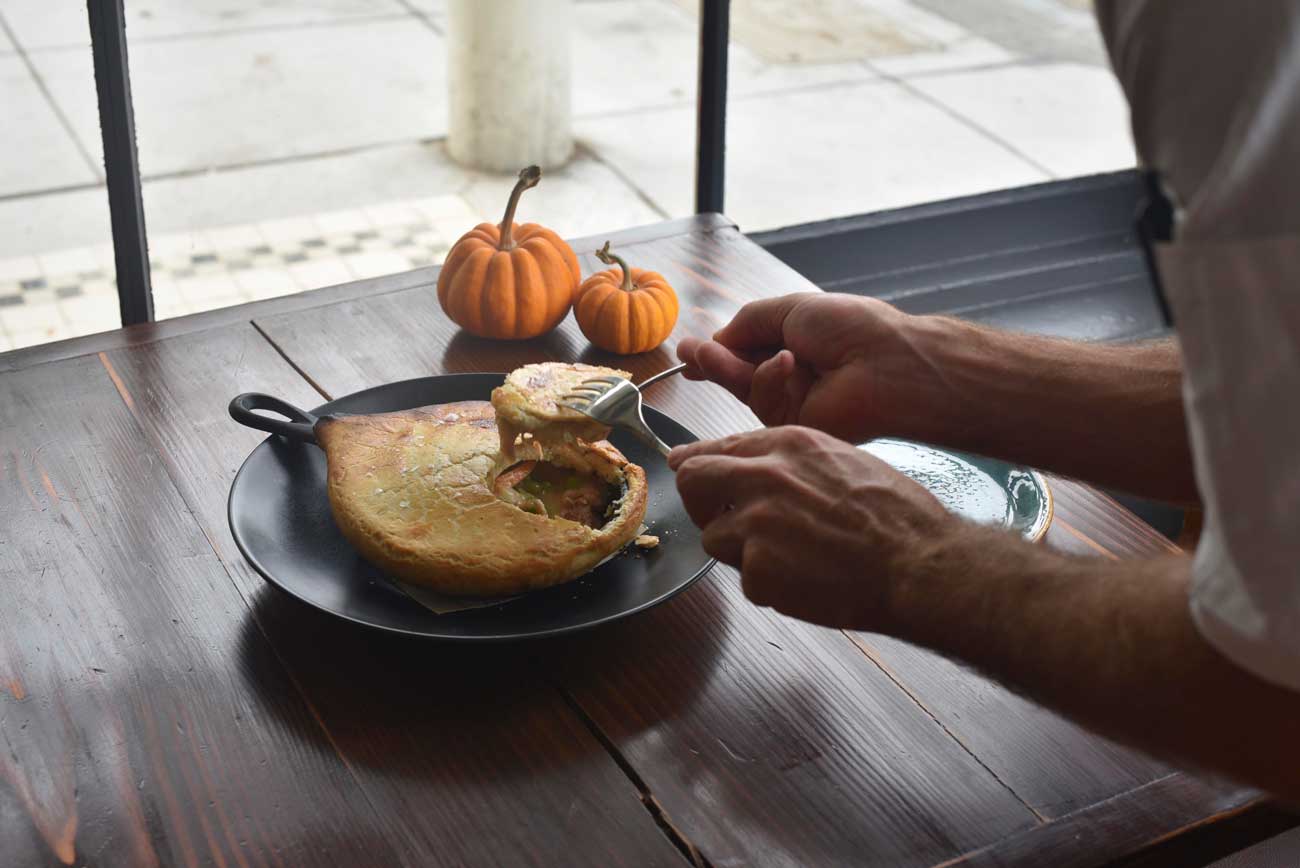 Chef Jonathan transfers the savory pot pie to the plate