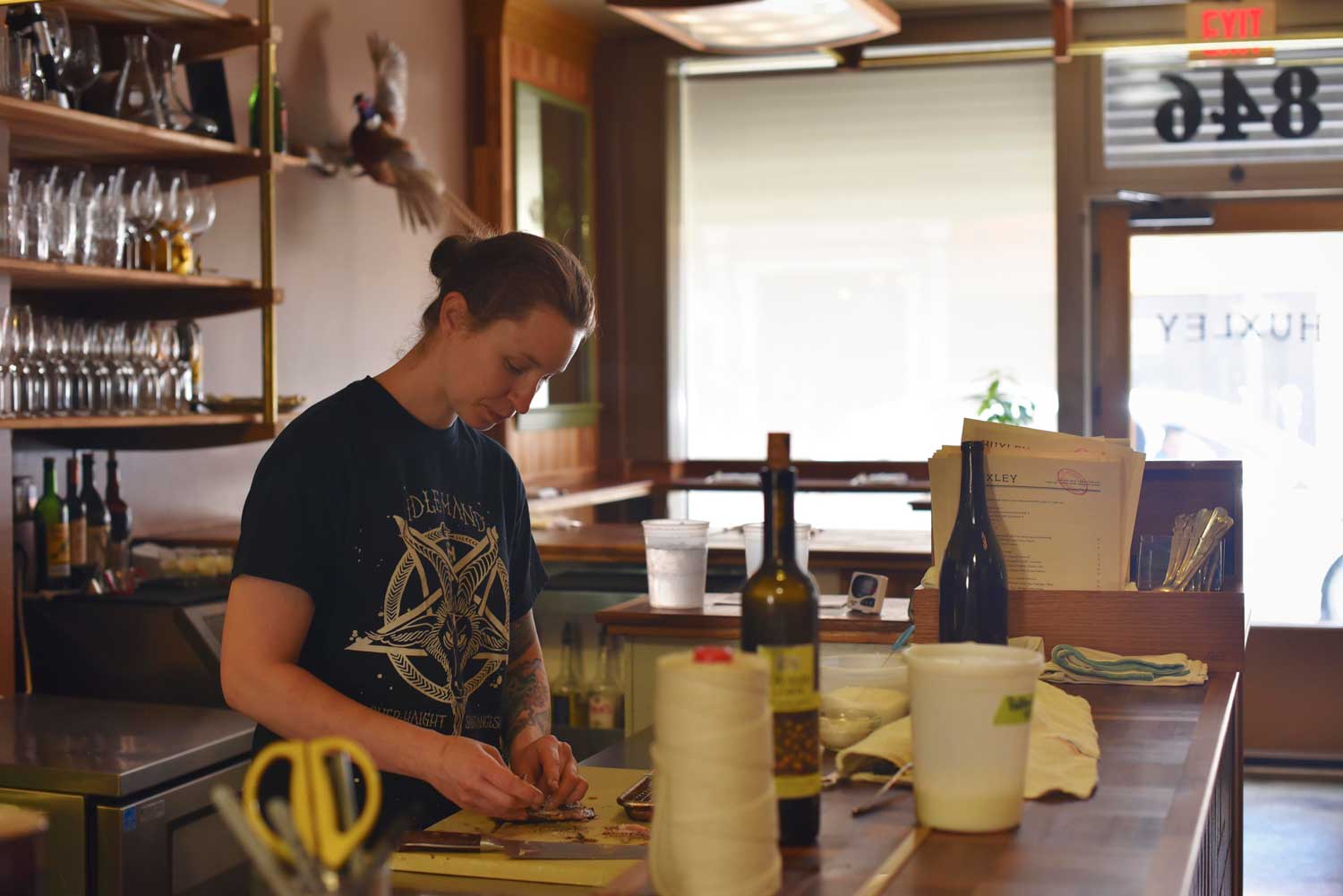 Chef Sara Hauman, who has a small team, debones fresh fish for preparation.