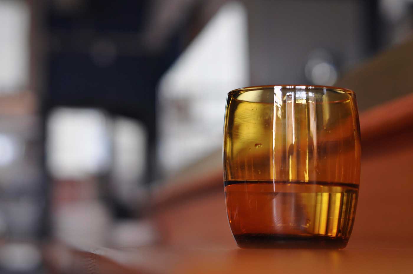 An orange glass rests on the oyster bar counter