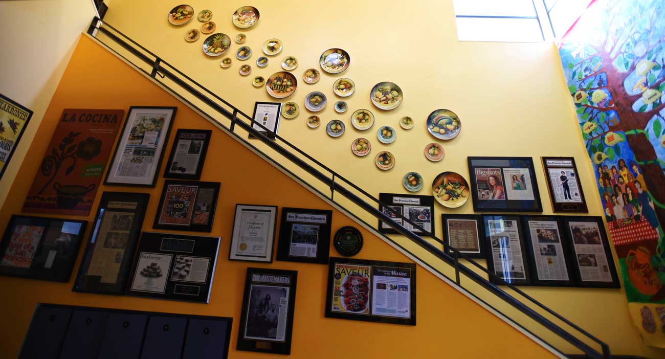Vibrant decorations and a mural adorn La Cocina's stairwell.