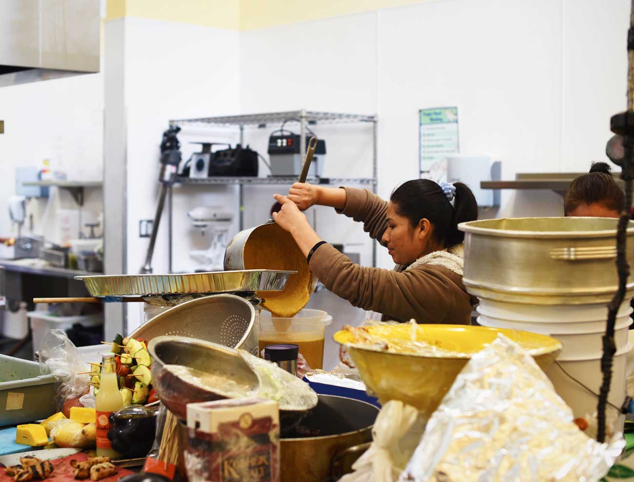 Caterers busily prep for a job and pour mixtures