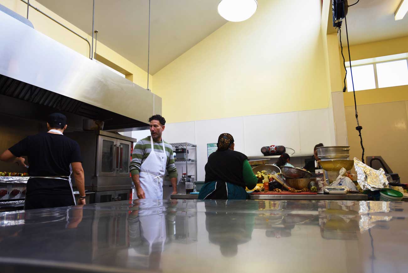 Reflections in the stainless steel of a busy commercial kitchen