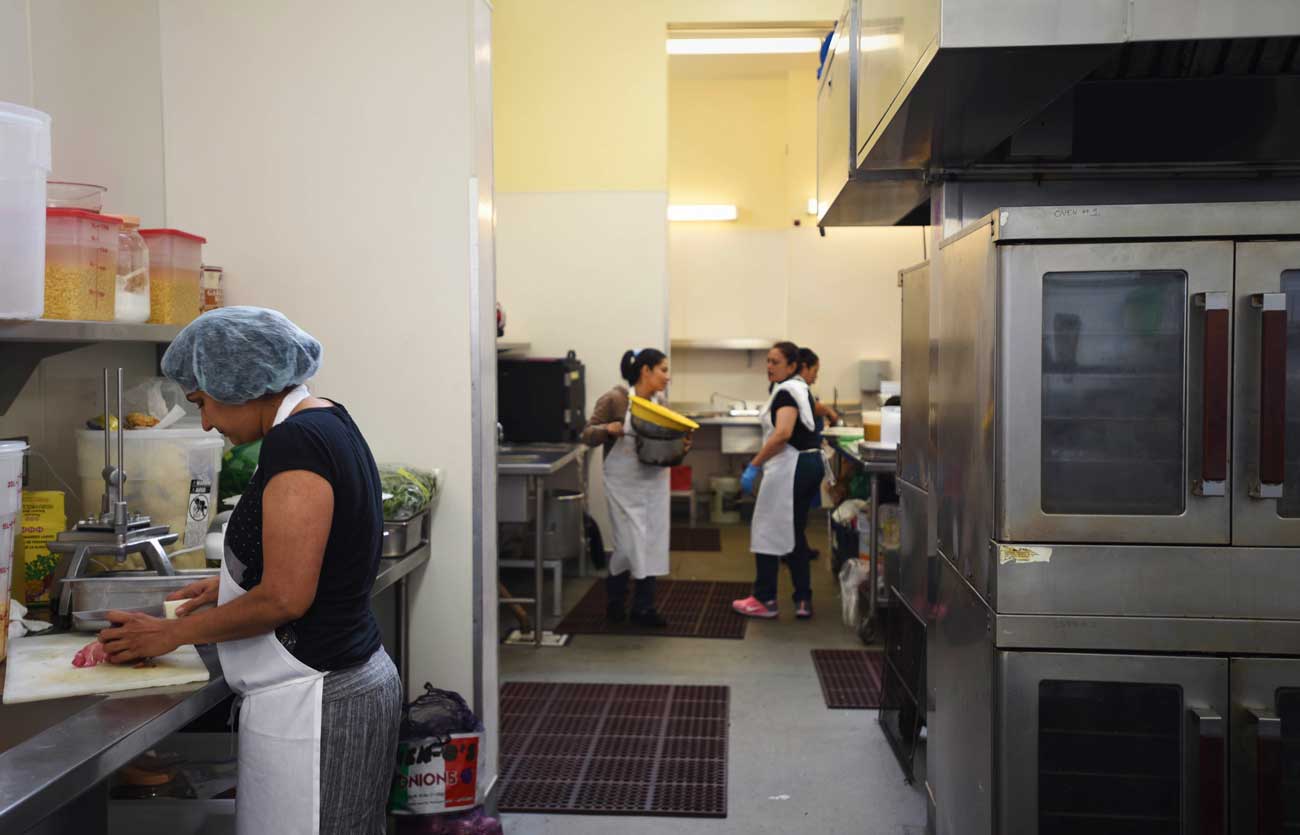 Teams of women entrepreneurs cook in La Cocina