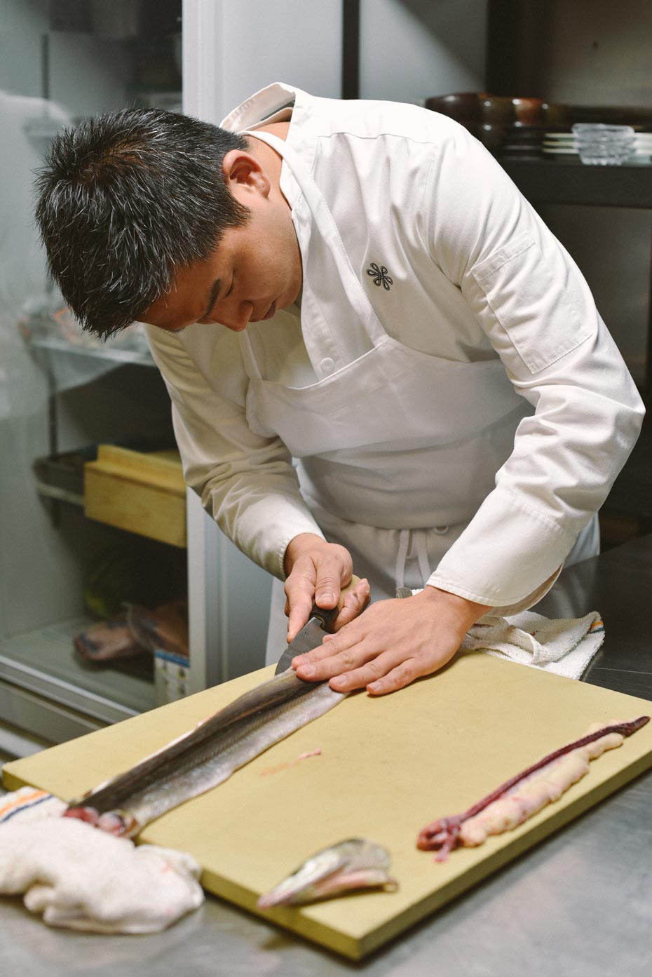 A fish is filleted by chef Anh 