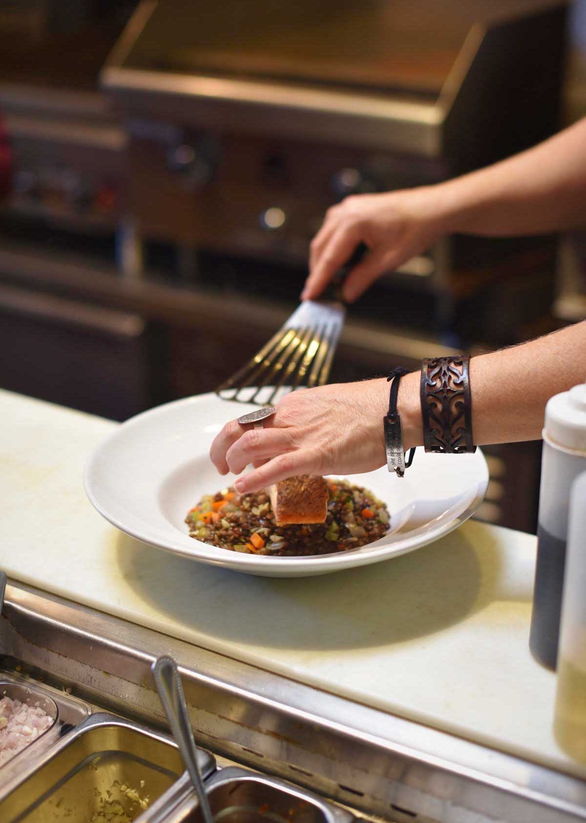 Fresh salmon is plated by chef Tracey at Myriad. 