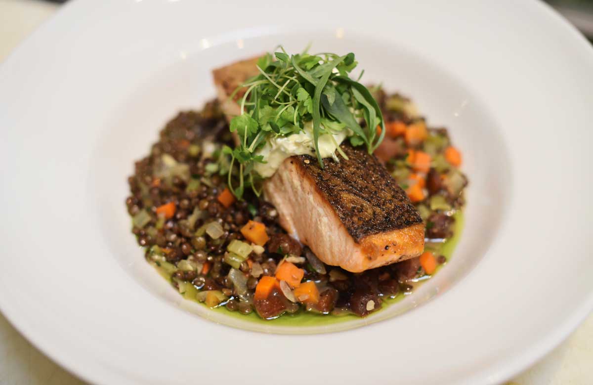 Pan roasted salmon with guanciale, lentils, sherry, herb aioli, and herb salad ($24)