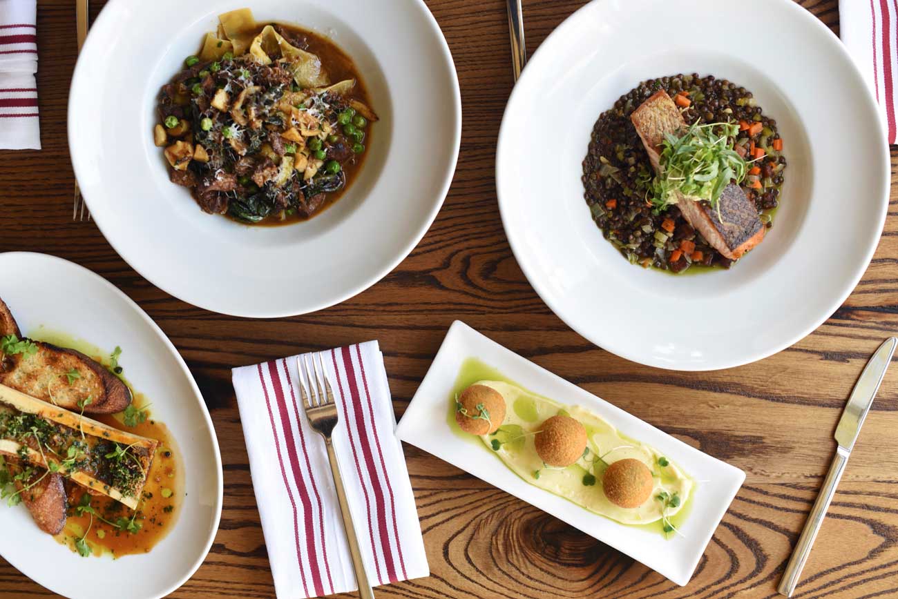 Popular dishes at Myriad represent a world's view of flavors: bone marrow with sherry demi-glace, pappardelle with pork cheeks, pan-seared salmon, and bacalaitos: salt-cod fritters with lemon aioli. 