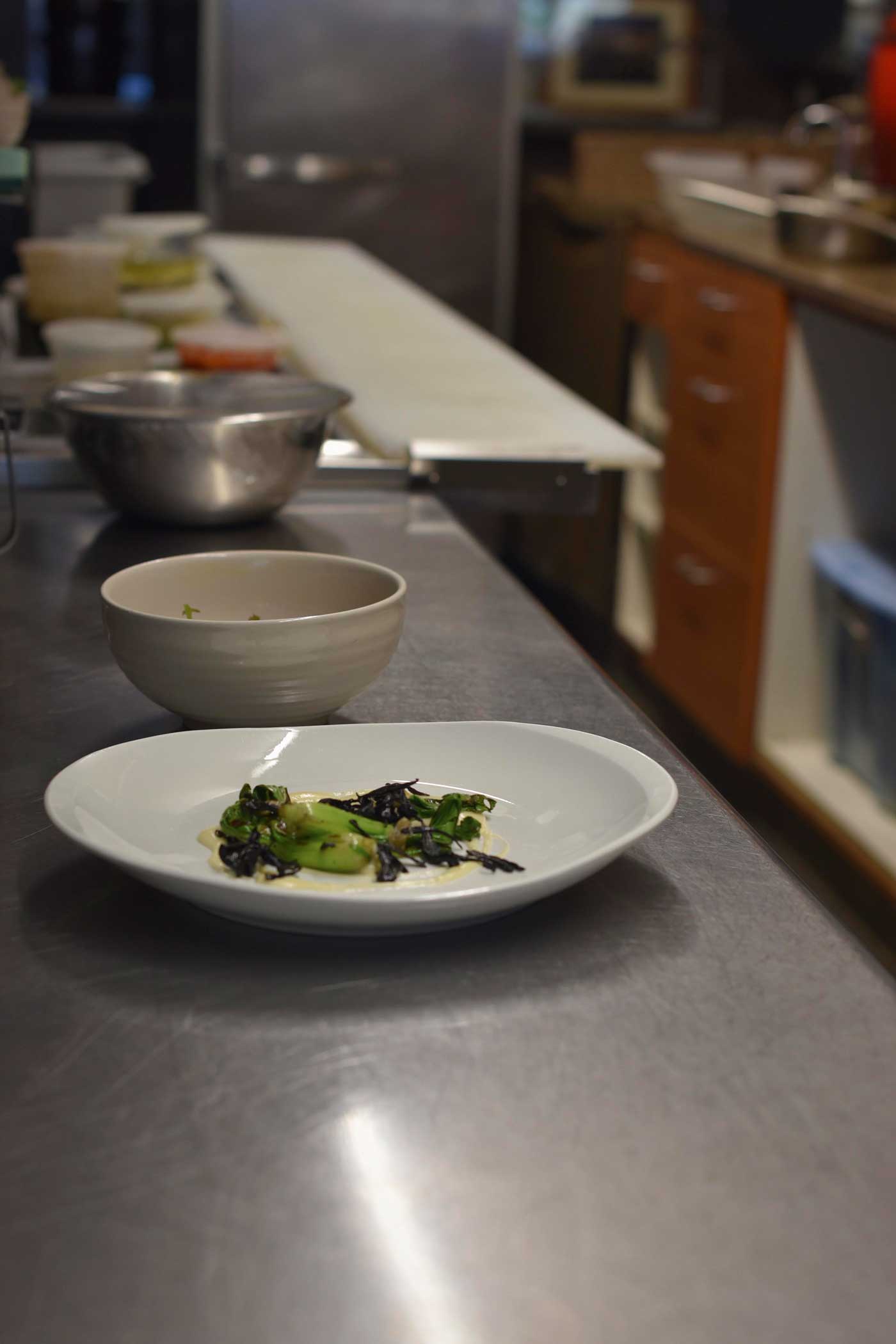 Plates are prepped on the steel counters in Prubehcu's kitchen.