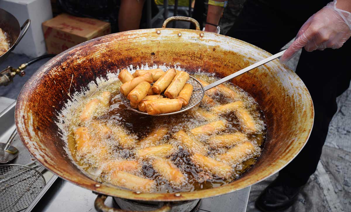 Freshly cooked egg rolls from Sataysfied are strained before being served at Outside Lands.