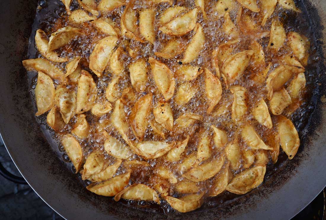 Potstickers, a favorite on the Sataysfied menu, brown to a crisp in a giant wok at Outside Lands.