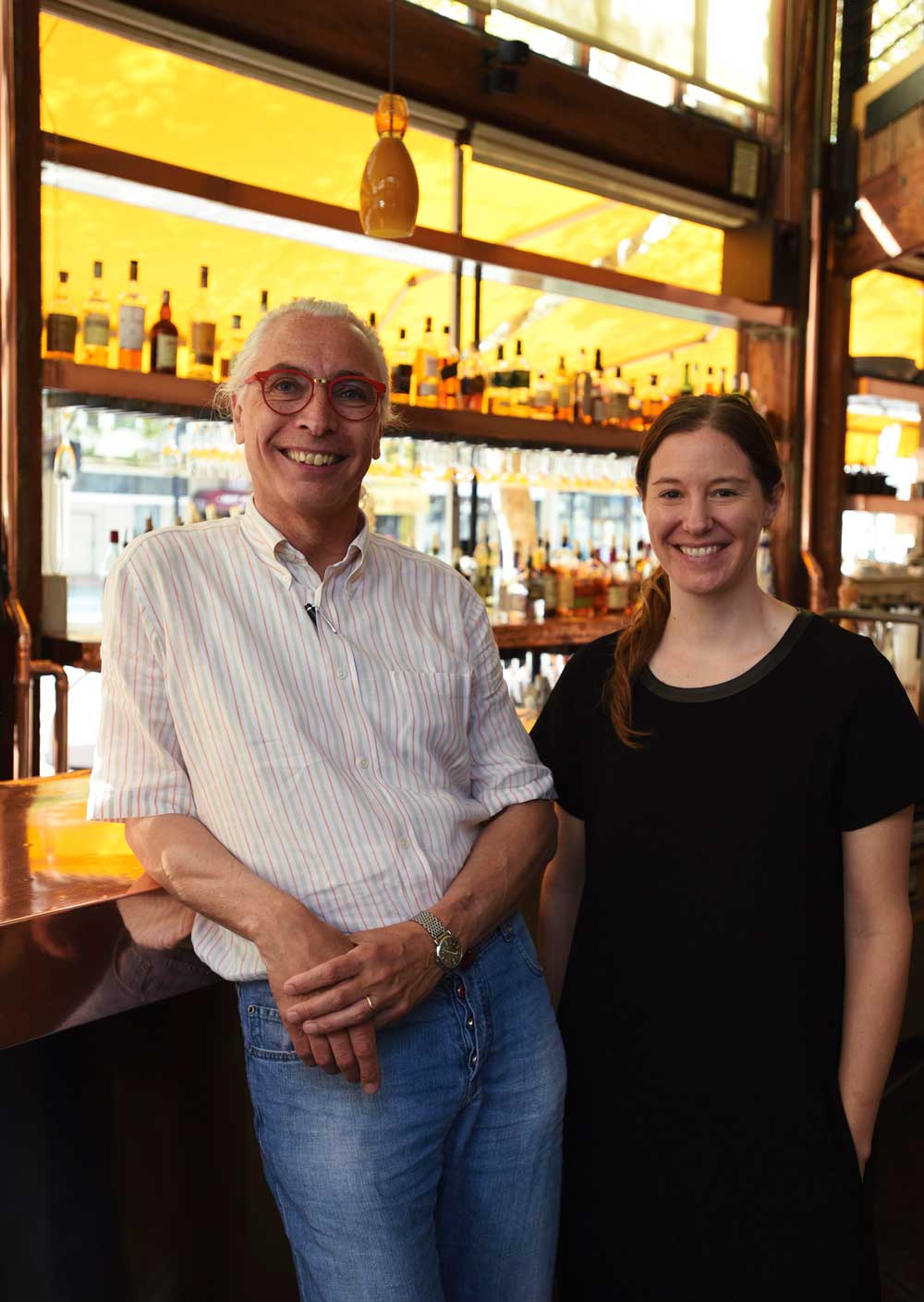Executive Chef Gilbert Pilgram and Head Chef Rebecca Boice lean against the hammered copper bar at Zuni Café.