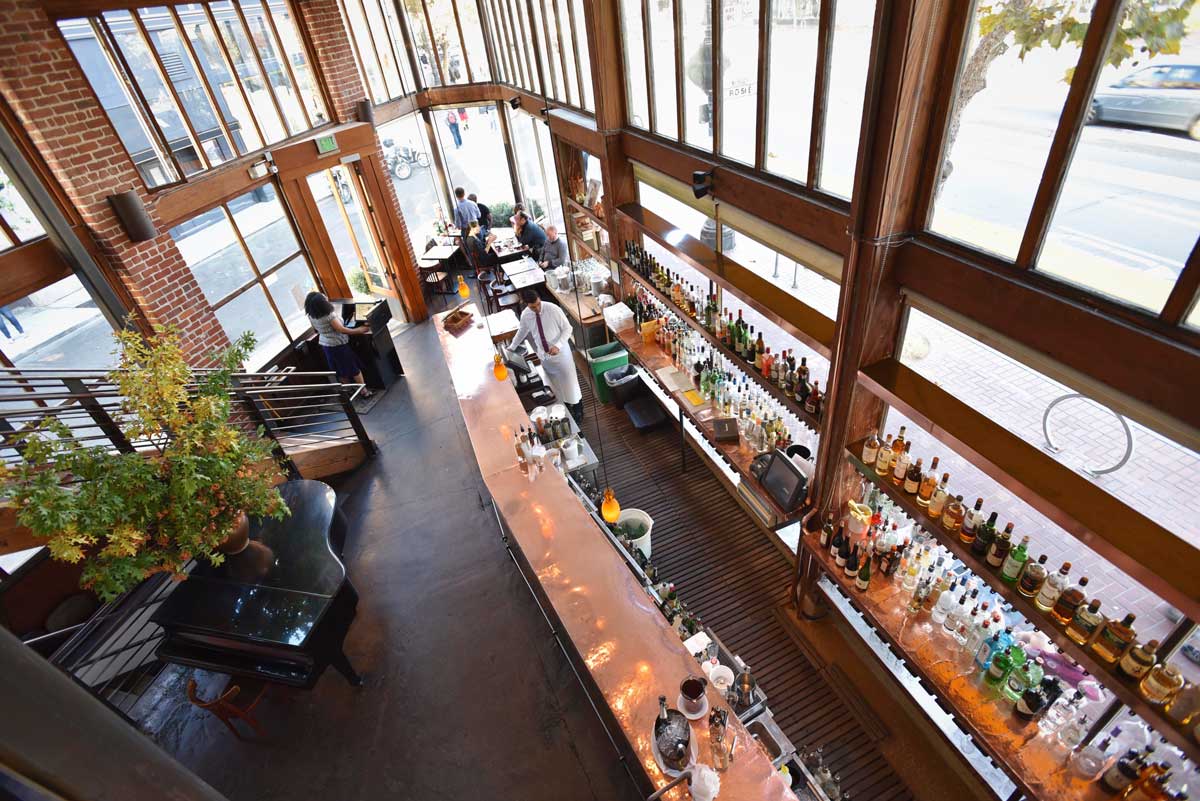 Floor to ceiling windows at Zuni Café, originally a cactus shop with plenty of natural light, usher in light and welcomes the city of San Francisco in for drink and a meal.