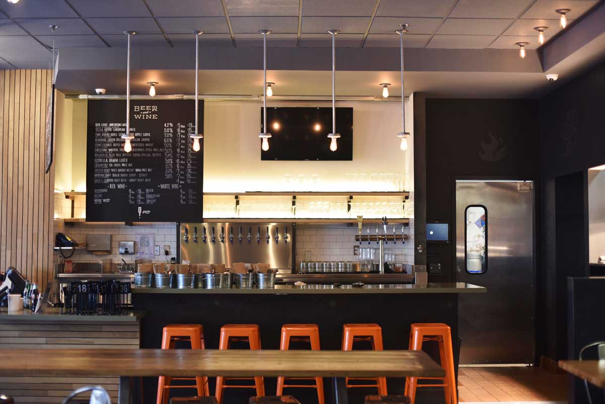 The bright and simple interior of Black Bark BBQ makes the spot approachable and comfortable to diners.