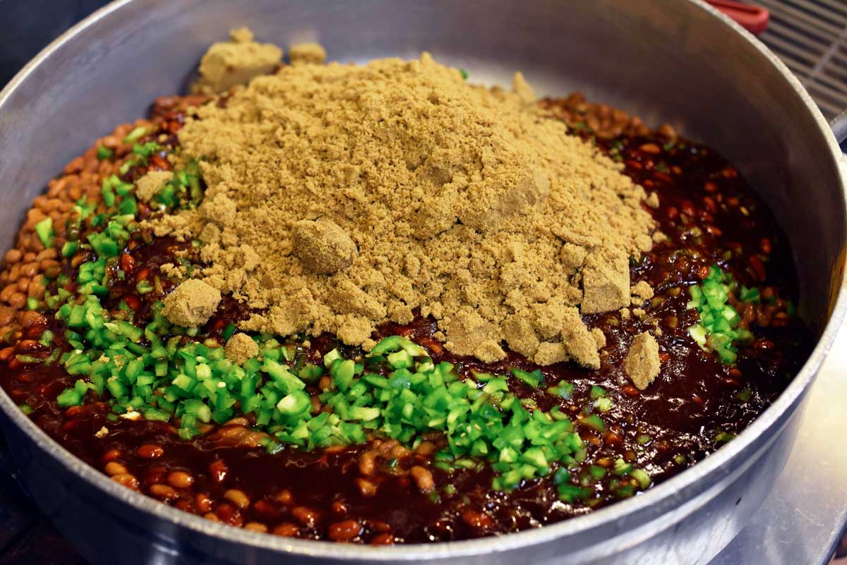 The beans are prepared with brown sugar, pepper, and a special broth.