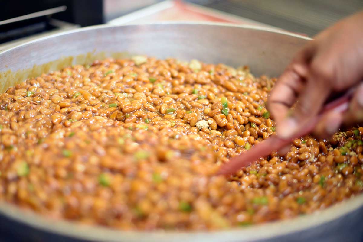 Chef David stirs the slow-cooked beans