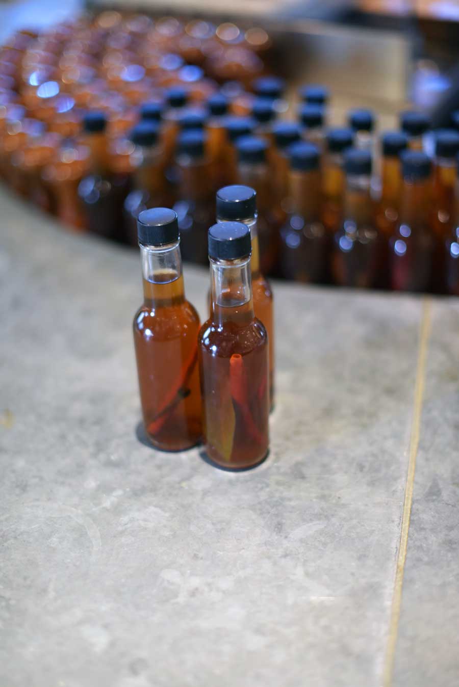 House made hot sauce is bottled in tiny portions at the raw bar