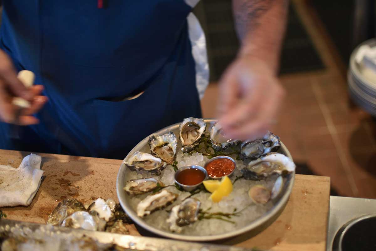 Oysters are prepared and plated