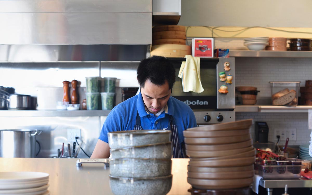Chef Kris Toliao prepares plates for lunch service 