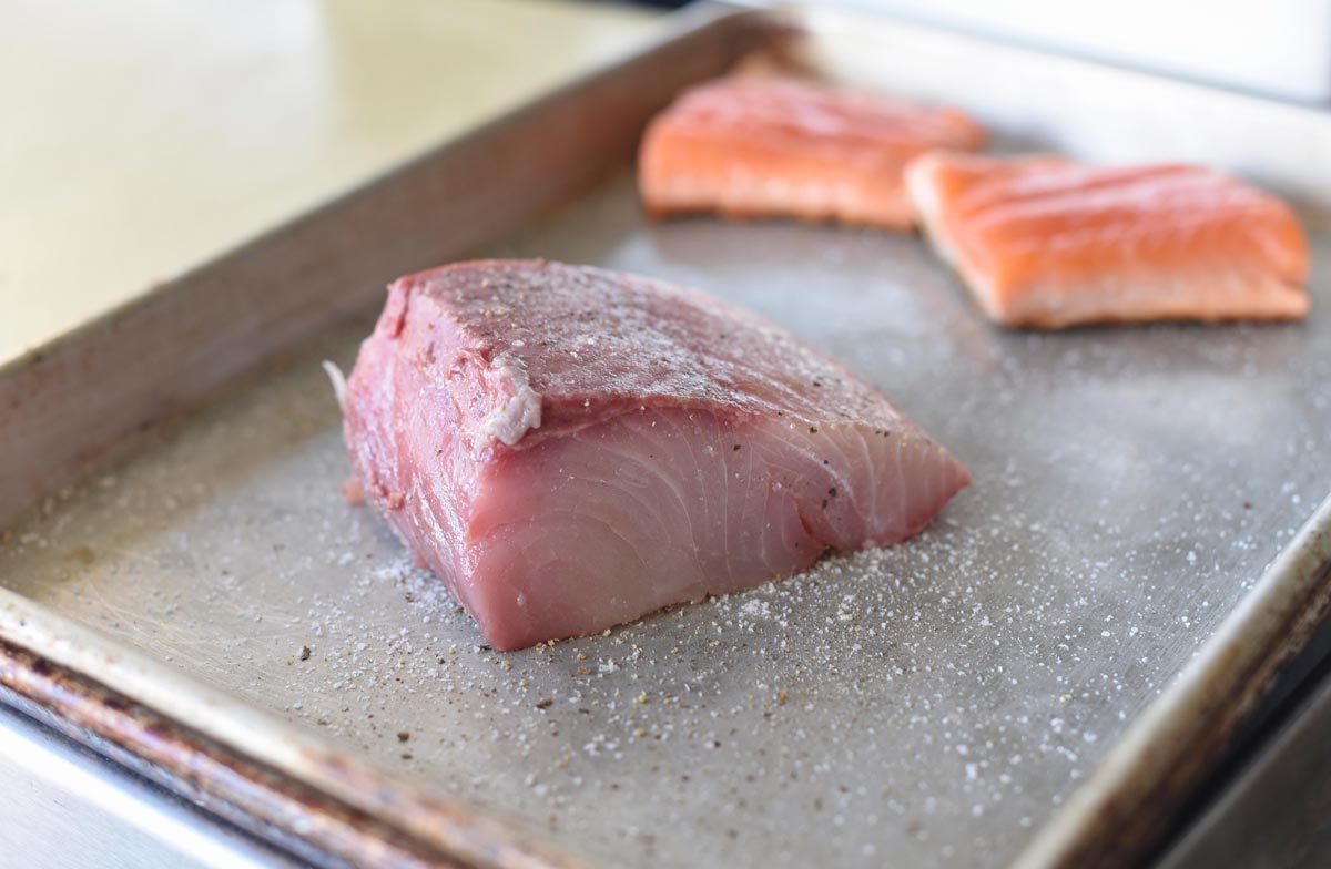 Fish steaks are salted at Cassava 