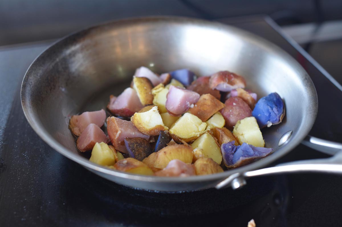 Potatoes of varying colors are pan seared 