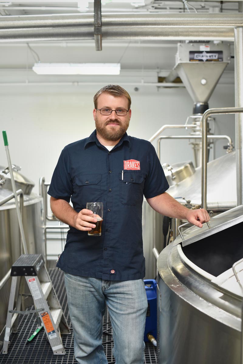Head Brewer Chris Dunstan enjoys a beer while reviewing the brew log 