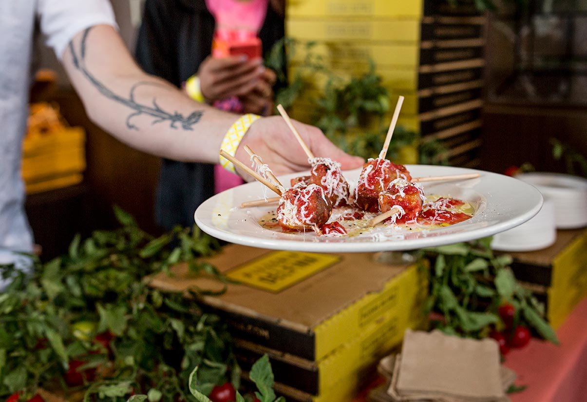 Chef Anthony Strong hands out a plate of Pizzeria Delfina appetizers at EDSF