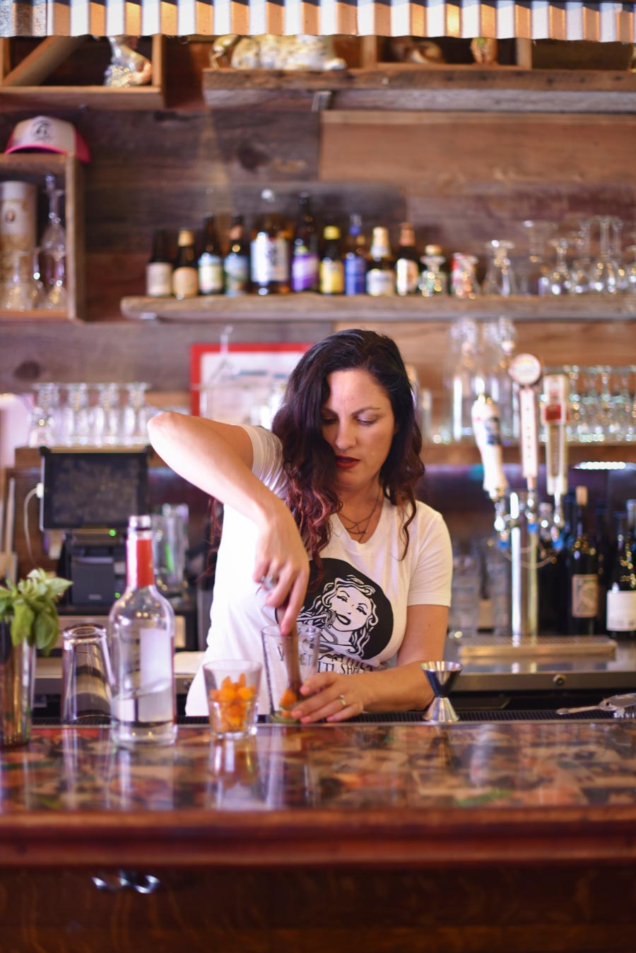 Emmy prepares a kumquat cocktail at the bar 