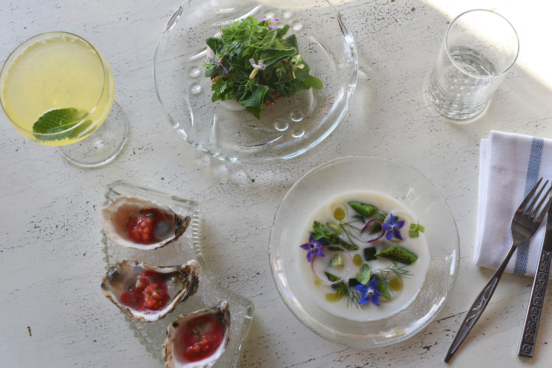 Sunlight drenches the table and fresh, light appetizers like onion cream soup, pate with fresh local herbs, and oysters with strawberries.