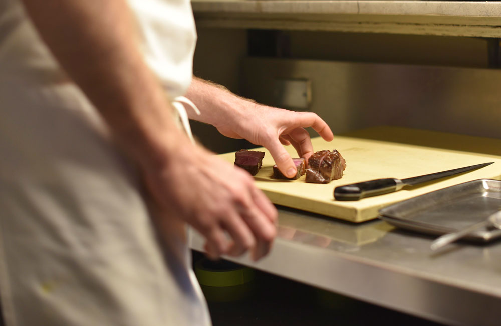 Chef Max prepares freshly grilled steak