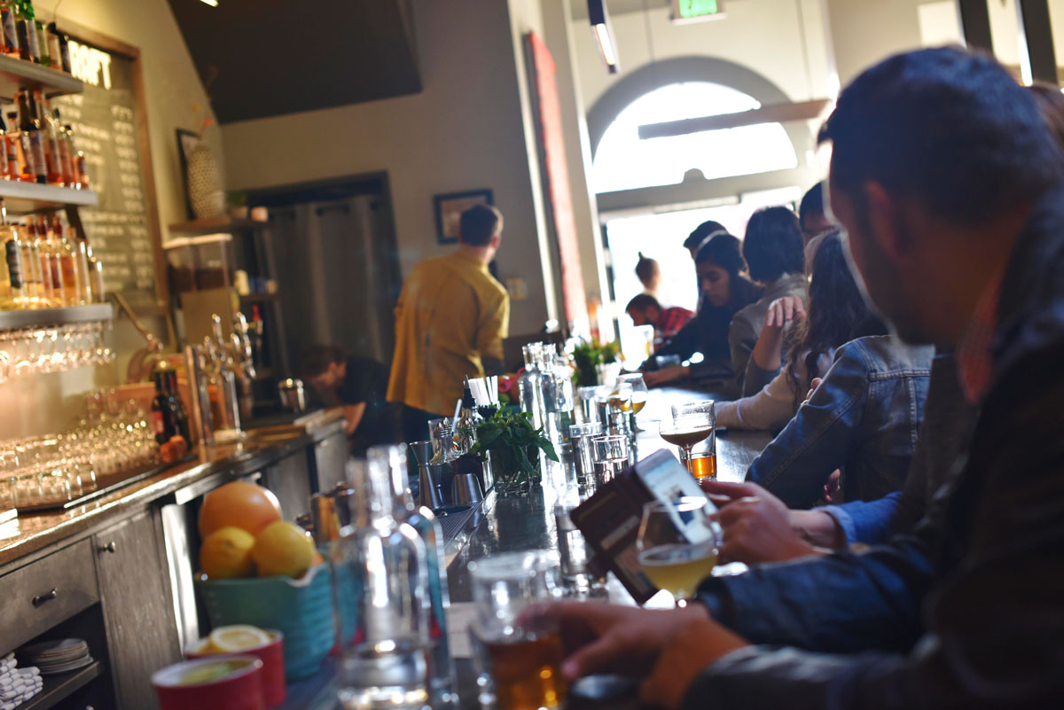 The bar fills with customers for summertime dinner service.