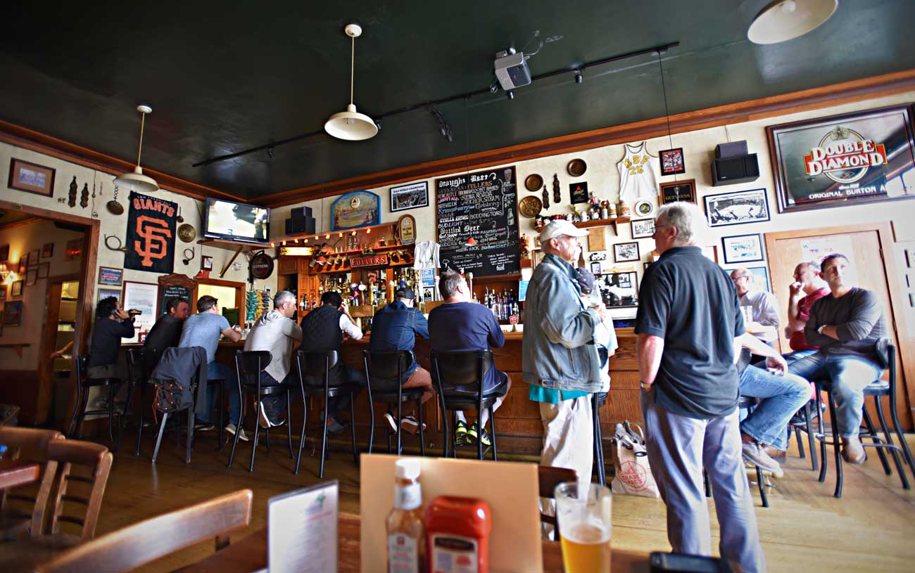 A crowd gathers around the bar on a foggy afternoon at San Francisco's Pig and Whistle.