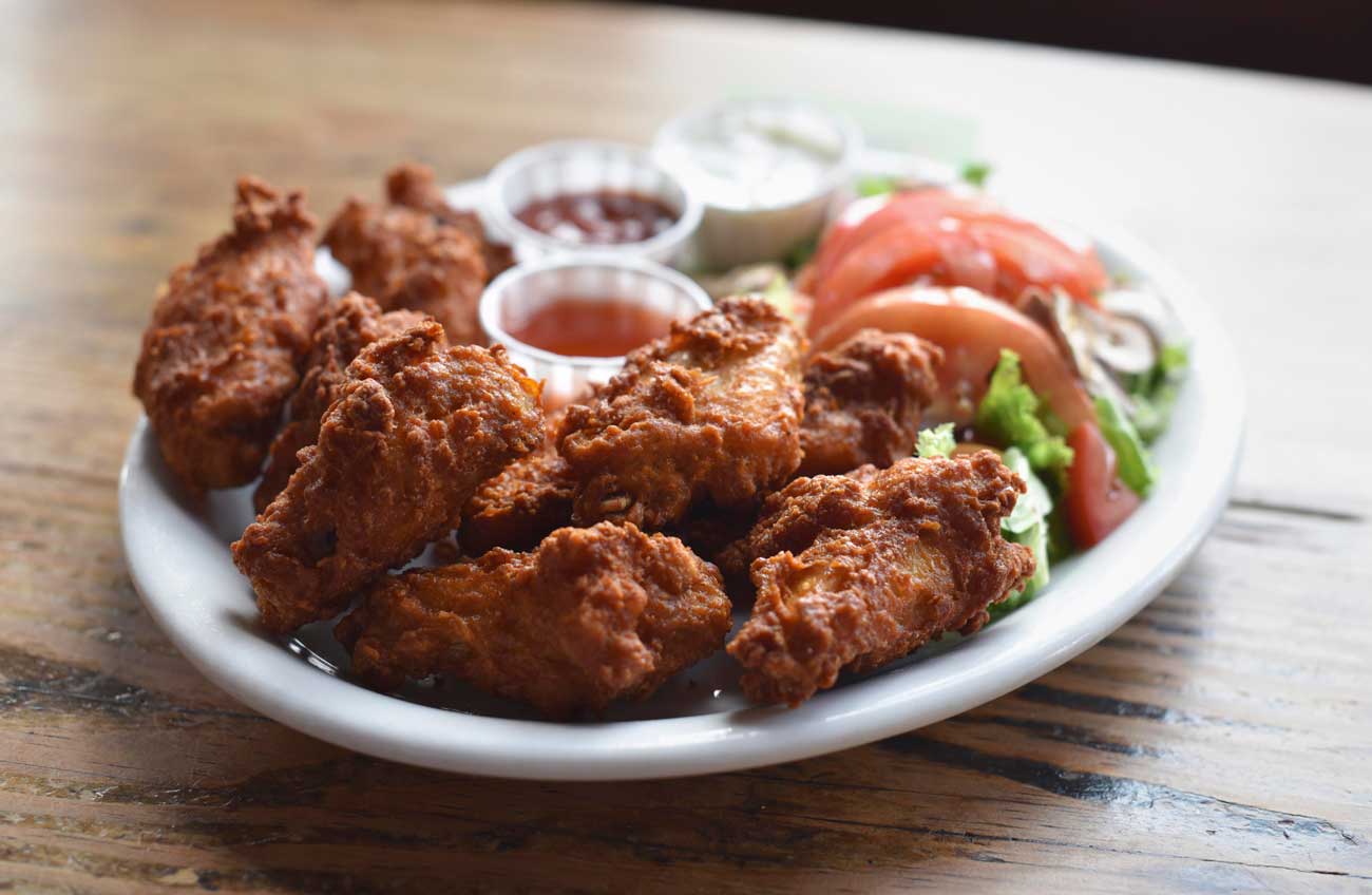 Fried chicken wings from the Pig and Whistle come with three different dipping sauces.
