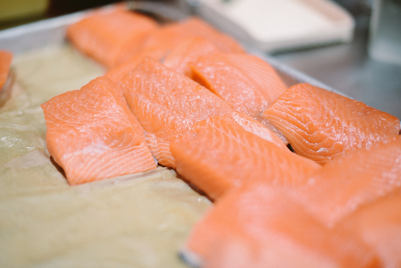Fresh salmon waits to be grilled on the open flame 