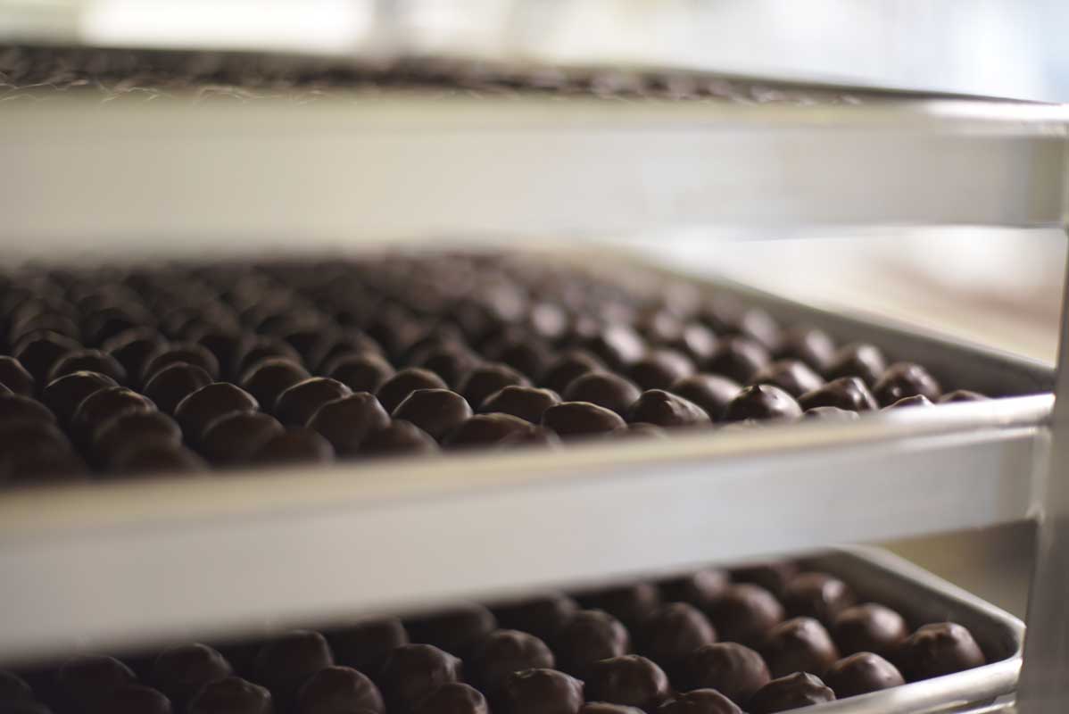 Trays of chocolates cool and wait to be packaged  