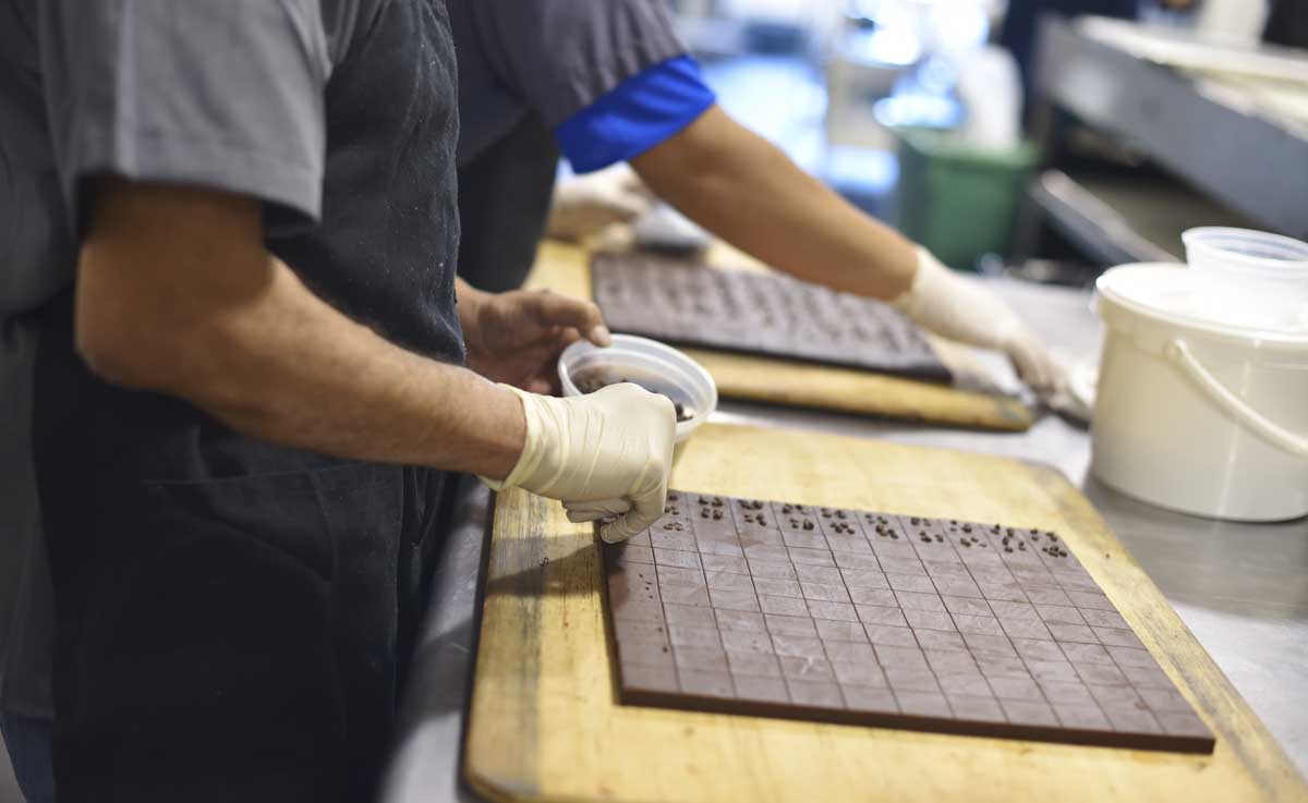 Recchiuti workers garnish chocolate pieces 