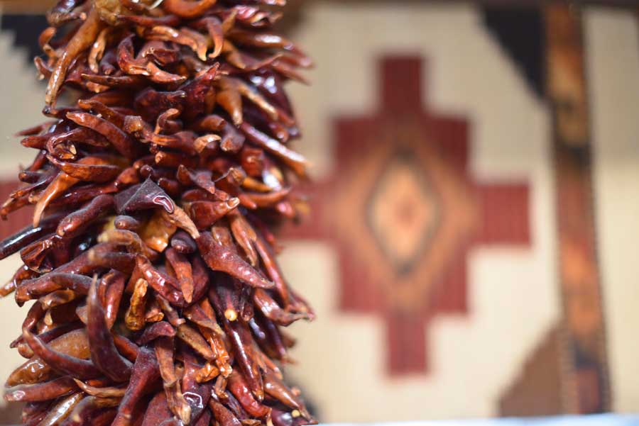 Dried chili peppers hang over the West of Pecos kitchen 