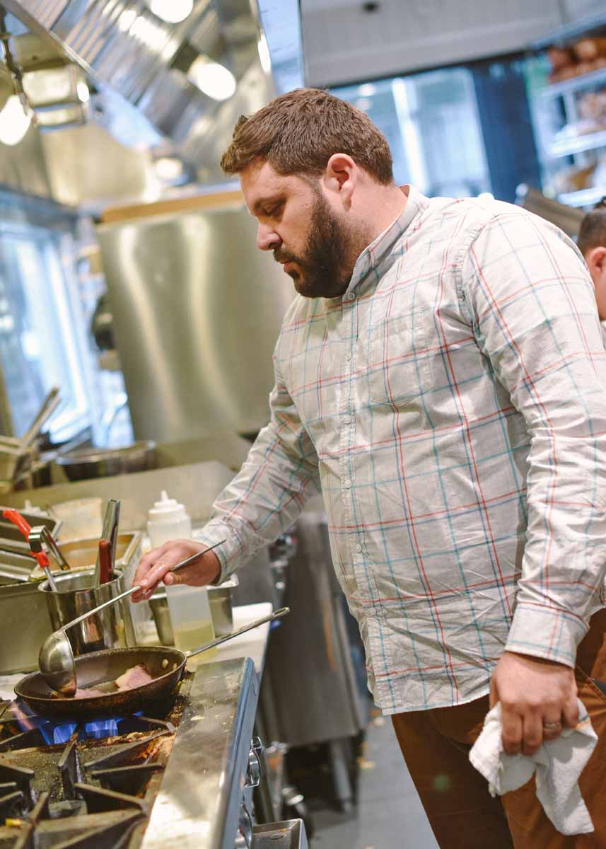 Evan Bloom prepares the day's special on the stove  