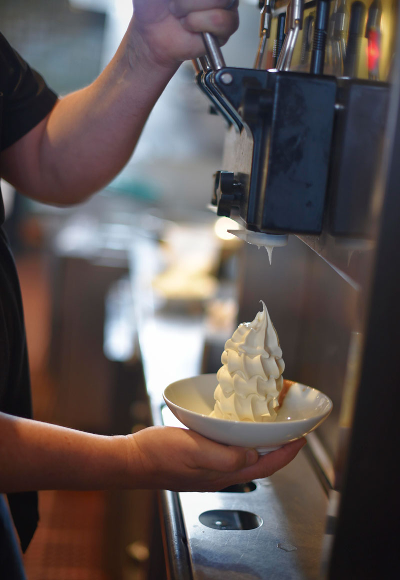 Hill fills a bowl with housemade soft serve ice cream 